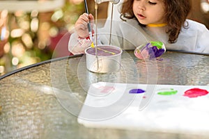 Little Girl Drawing On Stone Outdoors In Summer Sunny Day.