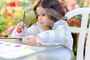 Little Girl Drawing On Stone Outdoors In Summer Sunny Day.