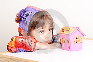 Little girl dreaming about house and family