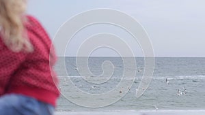 Little girl dreaming at the sea, looking at seegull