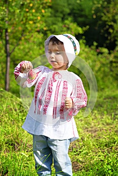 Little girl dresed in Romanian traditional blouse named ie