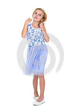 Little girl in a dress developing in the wind.