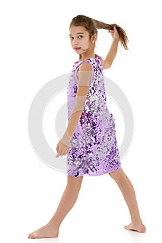 Little girl in a dress developing in the wind.