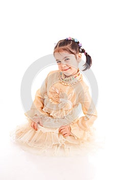 The little girl in a dress isolated on a white