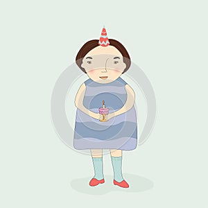 a little girl in a dress and with short dark hair and a cap on her head, holding a cake with a candle in her hands. Merry holiday,