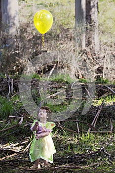 Little girl dressed as a fairy with a balloon