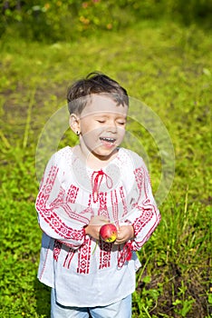 Little girl dressed in Romanian traditional blouse named ie laughing outdoors