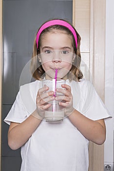 Little girl drinking a glass of milk