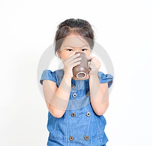 Little girl drinking the hot drink.
