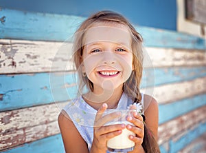 Little girl is drinking milk