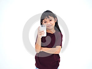 Little girl drinking milk on white background