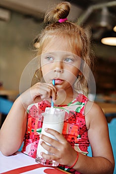 Little girl drinking milkshake