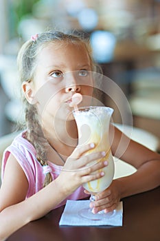 Little girl drinking milkshake