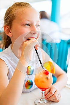 Little girl drinking mocktail outdoors