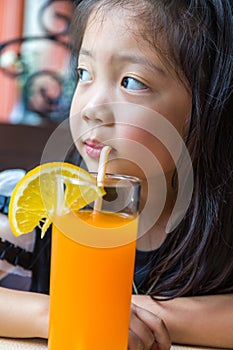 Little Girl Drinking Orange Juice