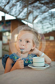 Little girl drinking tea from a cup