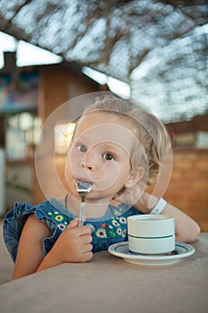 Little girl drinking tea from a cup