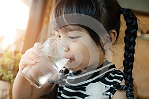 Little girl drinking water.