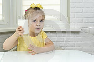 Little girl drinks milk