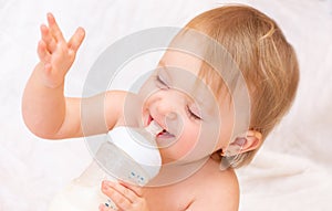 little girl drinks milk from a bottle. Baby food. concept of artificial feed