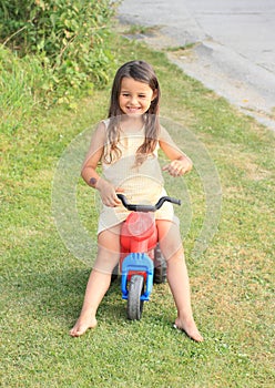 Little girl driving small kids motorbike