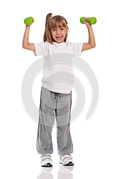 Little girl with dumbbells