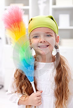 Little girl with dusting brush