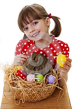 Little girl with easter rabbit and easter eggs