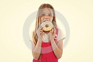 Little girl eat donut isolated on white. Child with glazed ring doughnut. Kid with junk food. Food for snack and dessert