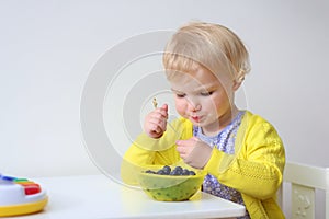 Little girl eating berries