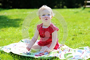 Little girl eating berries in the garden