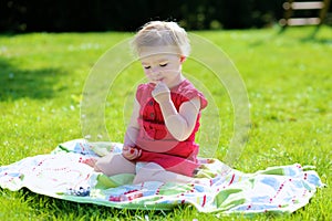 Little girl eating berries in the garden