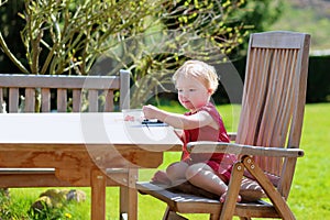 Little girl eating blueberries outdoors