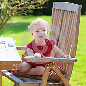 Little girl eating blueberries outdoors