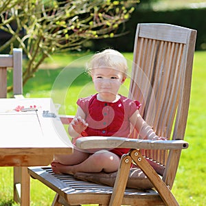 Little girl eating blueberries outdoors