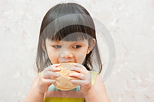 Little girl is eating bread