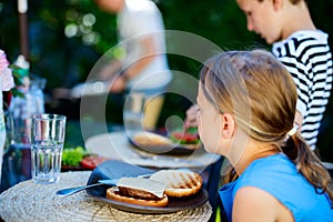 Little girl eating burger