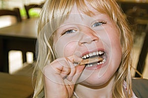 Little girl eating a cake