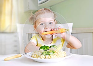 Little girl eating carrot,vegetables,healthy food.Child`s nutrition