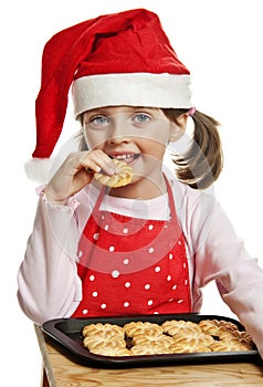 Little girl eating Christmas cookies
