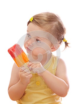 Little girl eating colorful ice lolly photo