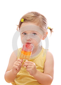 Little girl eating colorful ice lolly photo