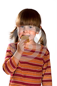 Little girl eating cookie