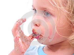 A little girl eating a cookie