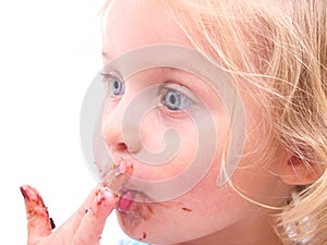 A little girl eating a cookie