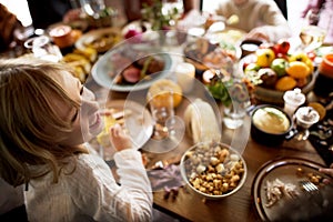 Little Girl Eating Corn Thanksgiving Celebration Concept