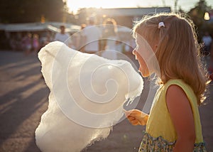 Little girl eating cotton candy