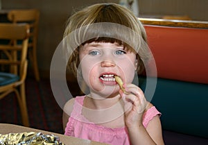 Little girl eating french fry