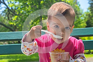 Little Girl Eating Ice cream Outdoor photo