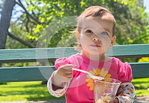 Little Girl Eating Ice cream Outdoor photo